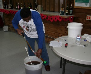 IMG_0900 Bob took a pH reading with a handheld pH meter. Then he collected a sample of the juice with a "wine thief" and put it in a cylinder for easy measuring of the specific gravity, brix, and potential ending alcohol percentage.